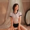 Short-sleeve form-fitting top with navy contrast collar and cuffs